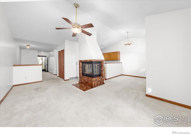 unfurnished living room featuring light carpet, ceiling fan with notable chandelier, and vaulted ceiling