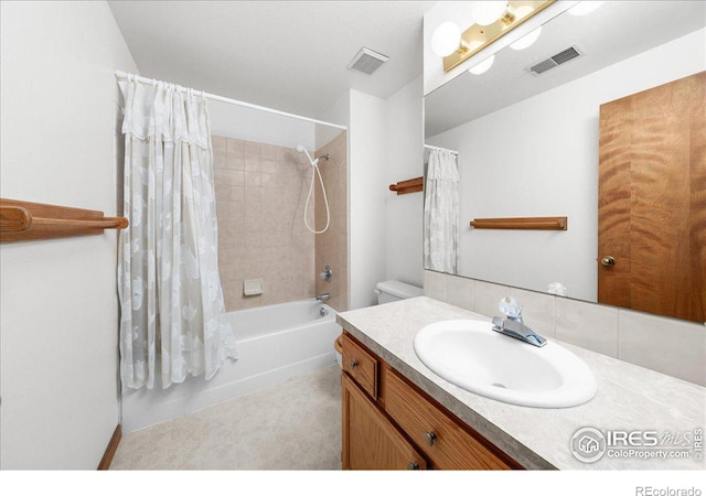 bathroom with shower / tub combo, visible vents, and vanity