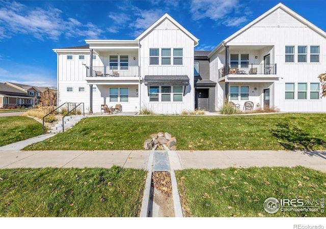 1820 Iron Wheel Dr Unit 3, Windsor, CO 80550 - view of front facade with a balcony, board and batten siding, and a front yard
