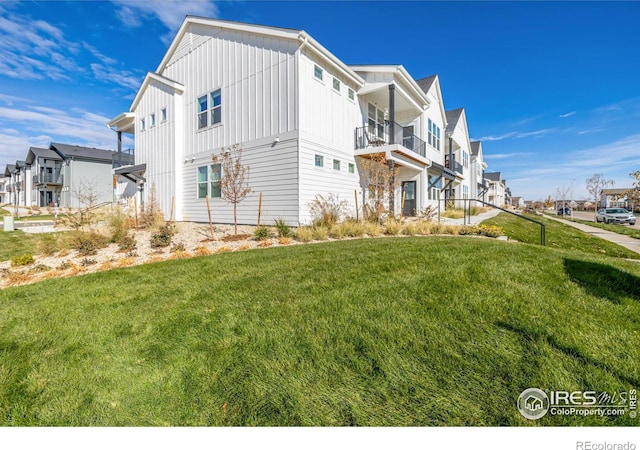 1820 Iron Wheel Dr Unit 3, Windsor, CO 80550 - view of home's exterior featuring a residential view, a lawn, board and batten siding, and a balcony