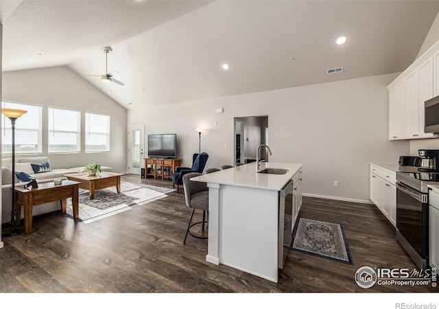 1820 Iron Wheel Dr Unit 3, Windsor, CO 80550 - kitchen with open floor plan, appliances with stainless steel finishes, ceiling fan, an island with sink, and high vaulted ceiling