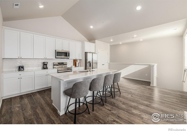 1820 Iron Wheel Dr Unit 3, Windsor, CO 80550 - kitchen featuring stainless steel appliances, a kitchen island with sink, dark wood-style flooring, white cabinetry, and recessed lighting