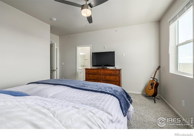 1820 Iron Wheel Dr Unit 3, Windsor, CO 80550 - carpeted bedroom featuring multiple windows, ensuite bath, and a ceiling fan
