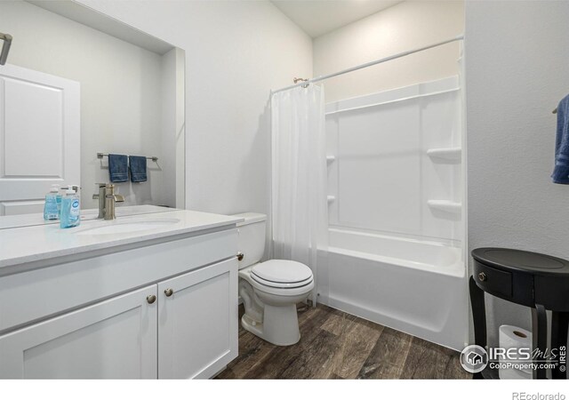 full bathroom with toilet, vanity, shower / bath combination with curtain, and hardwood / wood-style flooring