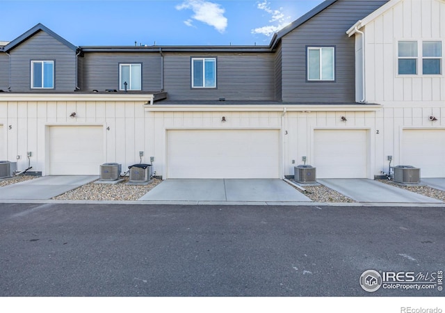 view of front of home featuring central AC and a garage