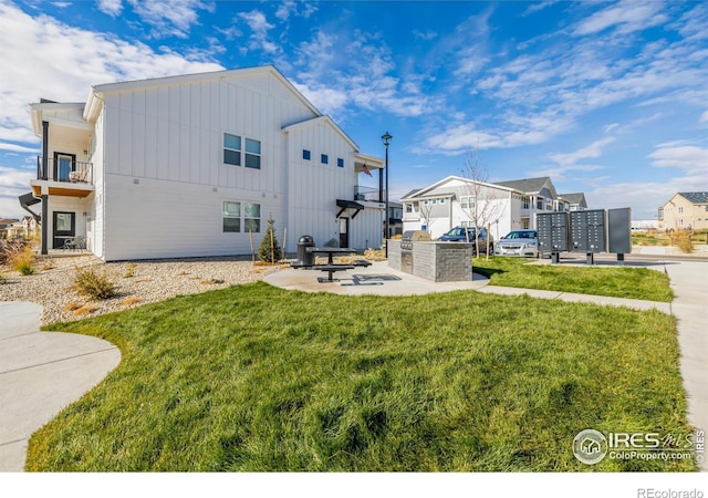 1820 Iron Wheel Dr Unit 3, Windsor, CO 80550 - rear view of property with board and batten siding, a yard, and a residential view