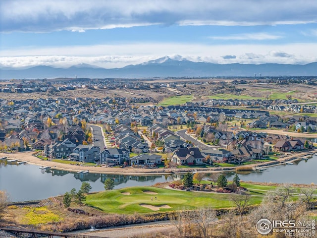 birds eye view of property with a water and mountain view