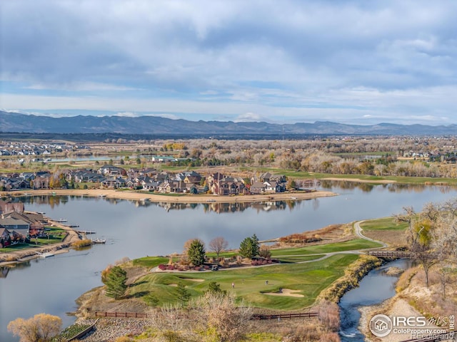 drone / aerial view with a water and mountain view