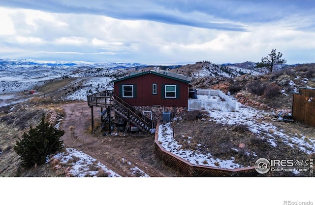 exterior space featuring central AC unit and a deck with mountain view