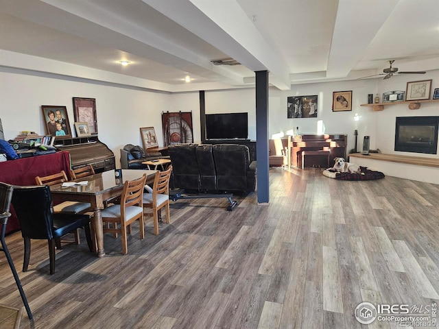 dining space featuring wood-type flooring and ceiling fan