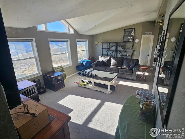 carpeted living room with vaulted ceiling