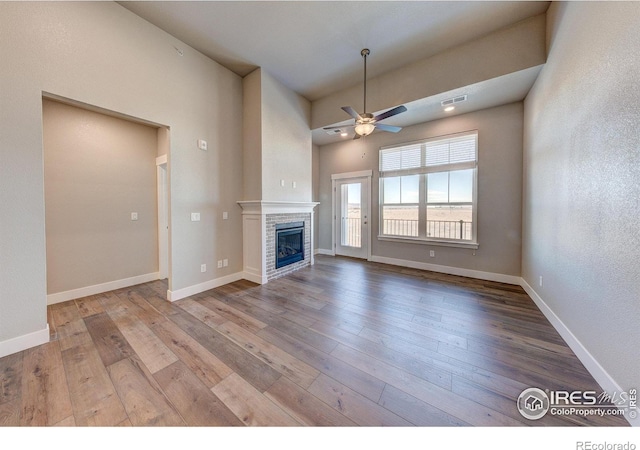 unfurnished living room with light hardwood / wood-style flooring and ceiling fan