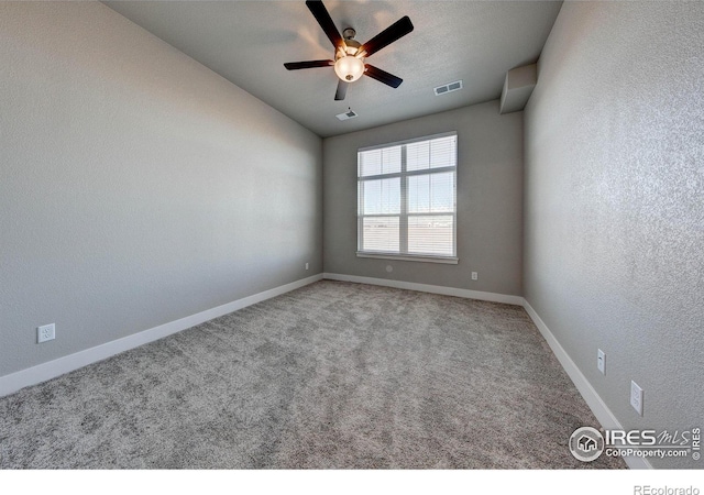 carpeted spare room with ceiling fan