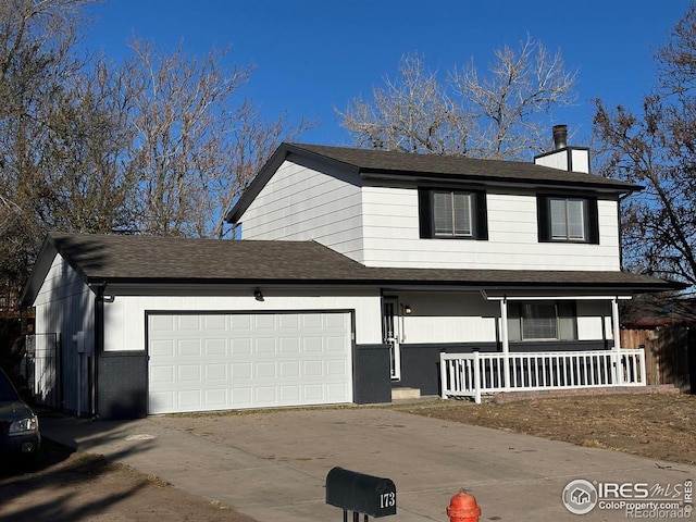 front of property featuring covered porch and a garage