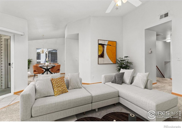 living room featuring lofted ceiling, light tile patterned floors, and ceiling fan