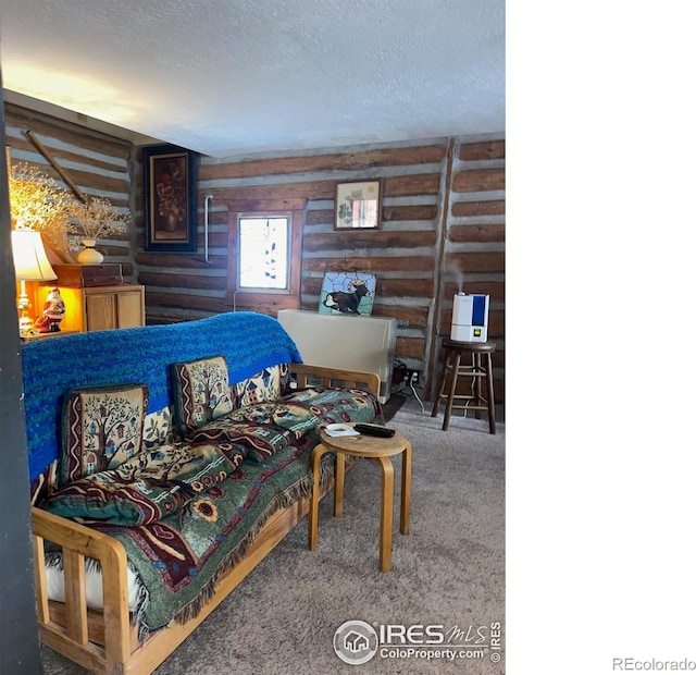 bedroom featuring carpet flooring, wooden walls, and a textured ceiling