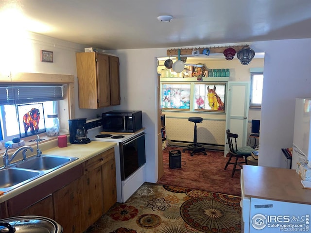 kitchen with baseboard heating, sink, white electric range oven, and dark carpet