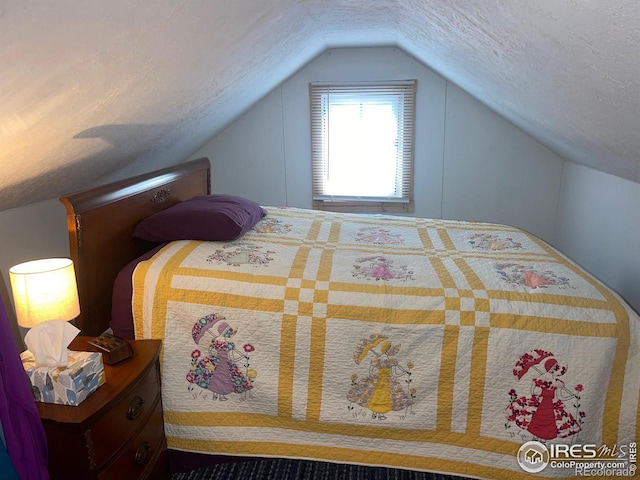 bedroom with a textured ceiling and lofted ceiling