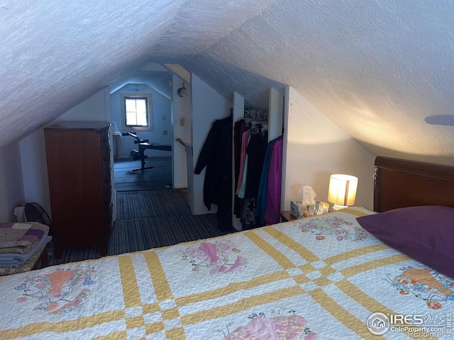 carpeted bedroom with a textured ceiling and lofted ceiling