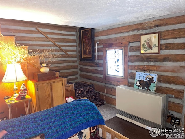 bedroom featuring a textured ceiling and heating unit