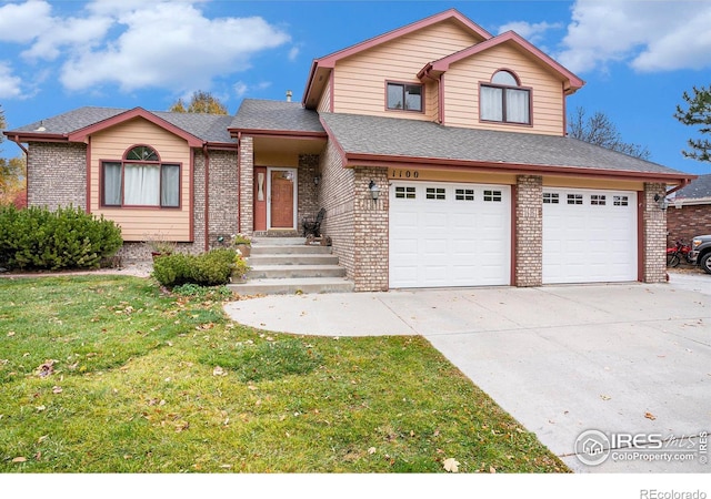 view of front property with a garage and a front lawn