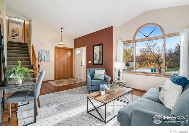 living room with vaulted ceiling and light hardwood / wood-style flooring