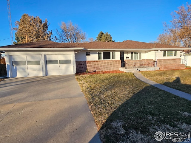 ranch-style house with a garage and a front yard