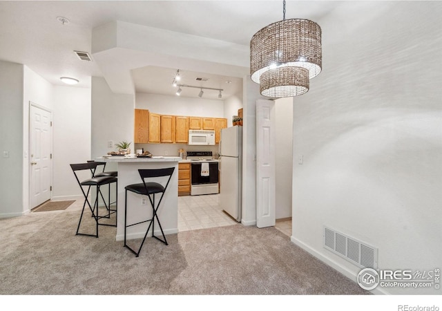 kitchen with light carpet, white appliances, visible vents, and light countertops