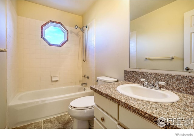 full bathroom with tiled shower / bath combo, toilet, and vanity