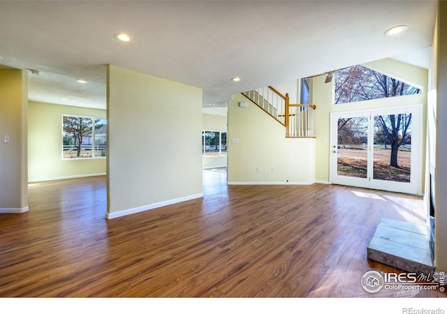 unfurnished living room with plenty of natural light and dark wood-type flooring