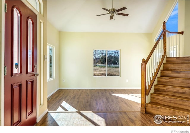 foyer entrance with ceiling fan and dark hardwood / wood-style floors