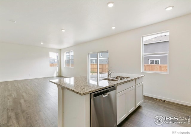 kitchen featuring white cabinets, a kitchen island with sink, sink, wood-type flooring, and dishwasher