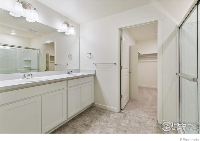 bathroom with vanity and an enclosed shower