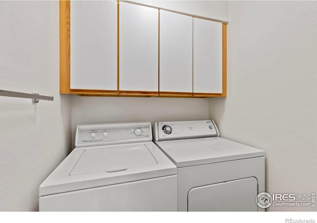 laundry area with cabinets and washing machine and dryer