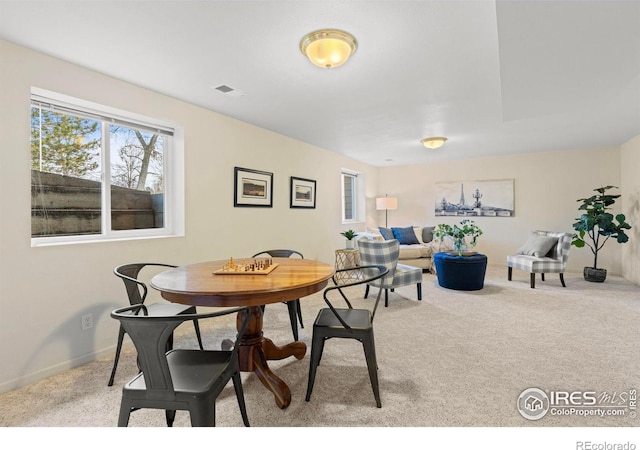 dining area with light colored carpet