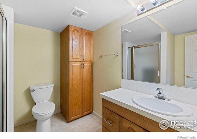 bathroom with vanity, an enclosed shower, and toilet