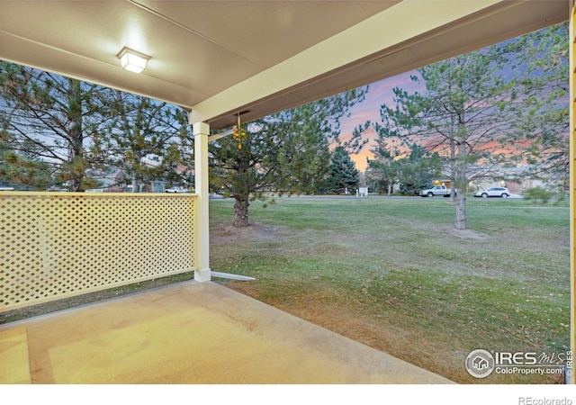 yard at dusk with a patio area