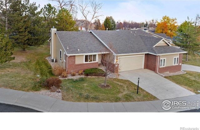 ranch-style house with a garage and a front lawn