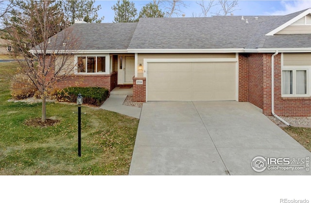 ranch-style home featuring a garage and a front lawn