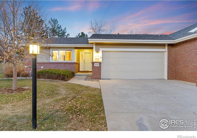 view of front of home featuring a lawn and a garage