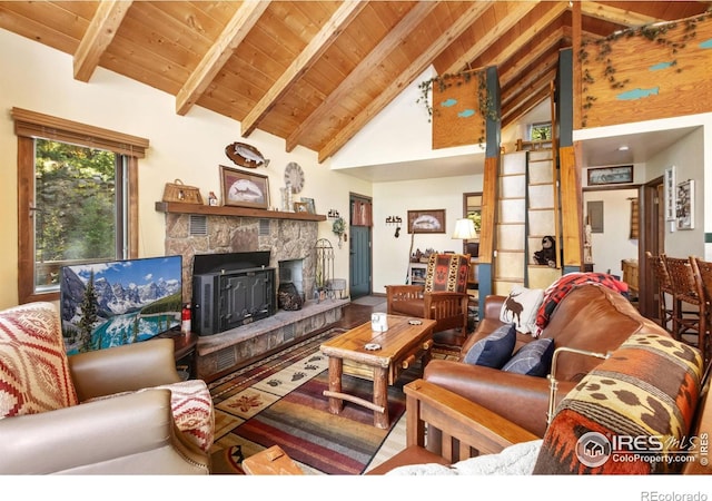 living room featuring beamed ceiling, high vaulted ceiling, a fireplace, and wooden ceiling