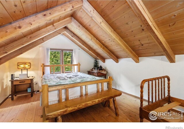 bedroom with lofted ceiling with beams, light wood-type flooring, and wooden ceiling