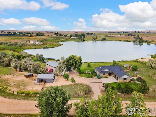 birds eye view of property with a rural view and a water view