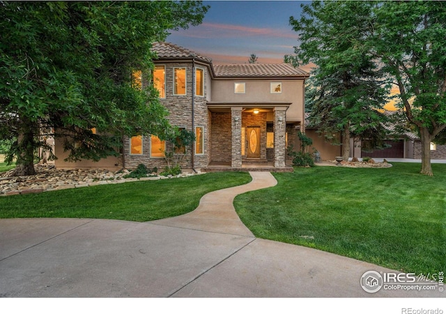 mediterranean / spanish-style home featuring a lawn