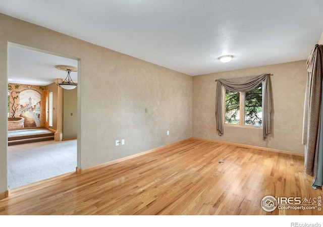 unfurnished room with wood-type flooring