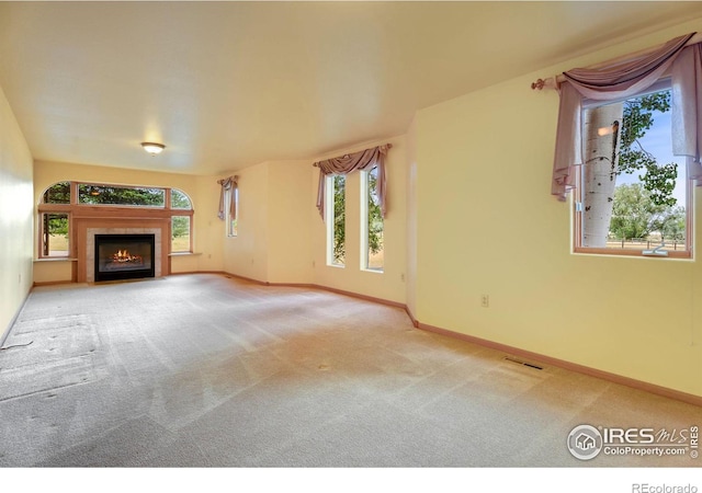 unfurnished living room featuring carpet floors