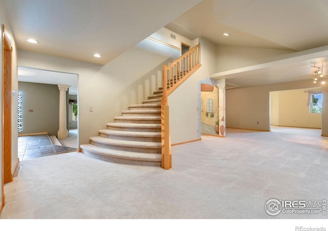 stairs featuring carpet flooring and ornate columns