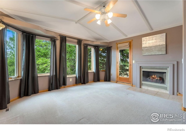 unfurnished living room featuring plenty of natural light, lofted ceiling with beams, and light carpet