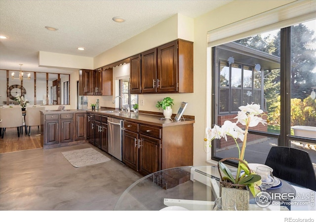 kitchen featuring dishwasher, kitchen peninsula, a textured ceiling, and a wealth of natural light