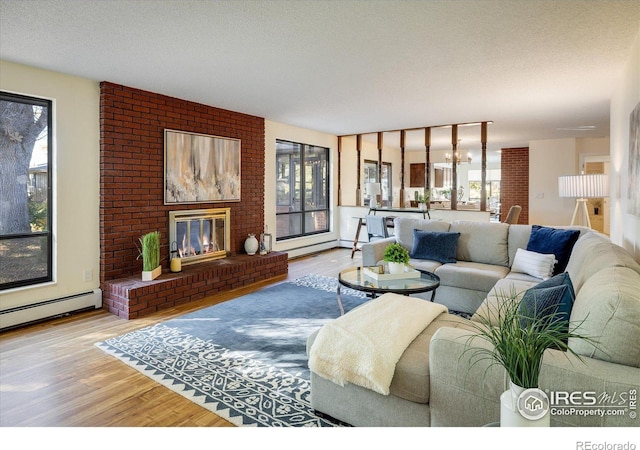 living room featuring a fireplace, hardwood / wood-style floors, and a healthy amount of sunlight